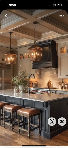 a kitchen with an island and stools in the center, surrounded by lights hanging from the ceiling