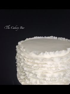 a cake with white frosting stacked on top