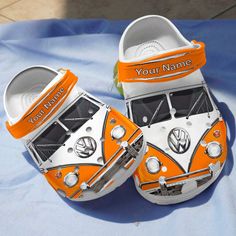 an orange and white vw camper van booties are on a blue sheet