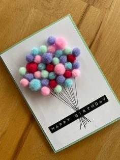 a birthday card with pom - poms on it