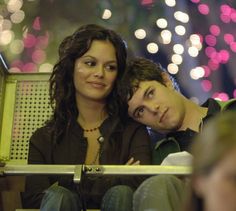 two people sitting next to each other on a bench