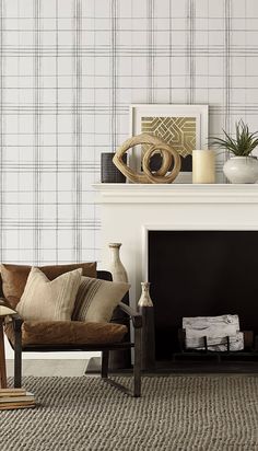 a living room with a fireplace, chair and pictures on the mantel above it