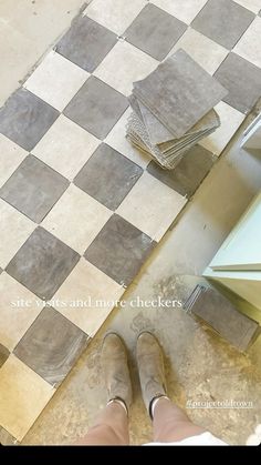 a person standing on a tiled floor next to a stove top oven and countertop