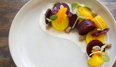 a white plate topped with food on top of a wooden table