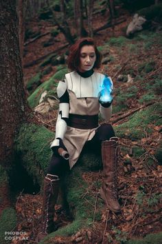 a woman dressed as star wars siting in the woods