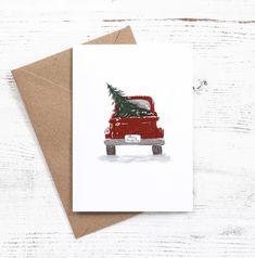 a red truck with a christmas tree in the back is on top of a card