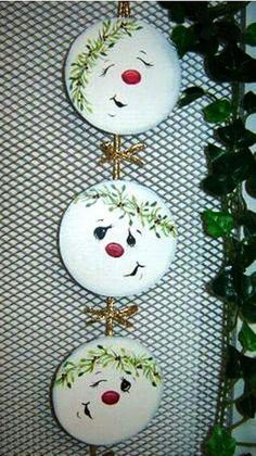 two white plates with faces on them sitting next to a potted plant in front of a screen shot