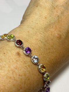 This genuine bright red garnet, citrine, blue topaz, amethysts, and peridot bracelet is very lively and bright. The stones are deep colors natural stones The sterling silver is plated with rhodium to protect the bracelet from tarnish 7.5 in Our jeweler can shorten it for $20 All jewelry is shipped free in the US in a nice gift box. Check out our over a THOUSAND great reviews Engraving is $4 per letter and is not always perfect depending on the piece. It can take a few days if the jeweler is busy Sterling Silver Multi-stone Bracelet, Multicolor Gemstone Crystal Bracelet, Sterling Silver Multi-stone Round Bracelet, Multicolor Round Sterling Silver Bracelet, Elegant Multicolor Sterling Silver Bracelet, Sterling Silver Multicolor Gemstone Bracelets, Sterling Silver Multicolor Gemstone Bracelet, Elegant Multicolor Sterling Silver Bracelet With Stones, Multicolor Sterling Silver Bracelets With Gemstone Accents