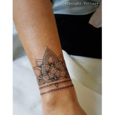 a woman's arm with a tattoo on it and a flower in the middle