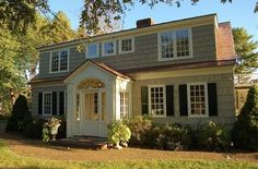 a house with white trim and black shutters