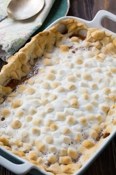 a casserole dish filled with pudding on top of a wooden table