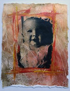 an altered photograph of a baby's face in red and orange squares on white paper