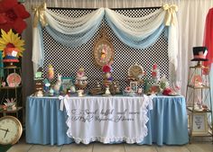 a table topped with lots of different types of items next to a wall mounted clock