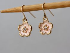 Delicate and cute Cherry Blossom Earrings Pale Pink Cherry Blossoms charms 13 x 13 mm Tiny Cubic Zirconia in a center Gold Plated French Ear Wire. Alloy Metal. The total length is 25 mm or almost is 1 inch long * * * * * * * * * * * * * * * * * * * * * * * * * * * * * * * * * * Matching Necklace with Single charm is available here - https://www.etsy.com/listing/686400195/cherry-blossoms-pale-pink-flowers-spring - - - - - - - - - - - - - - - - - - - - - - - - - - - - - - - - - - - - - - - - Match Cute Rose Gold Flower Jewelry, Cute Flower Shaped Jewelry With Matching Earrings, Cute Rose Gold Jewelry With Matching Earrings, Cute Flower Earrings For Mother's Day Gift, Delicate Flower Earrings For Spring Gift, Cute Rose Gold Jewelry With Flower Charm, Cute Rose Gold Flower-shaped Jewelry, Dainty Flower Earrings For Mother's Day, Cute Flower Charm Earrings For Gift