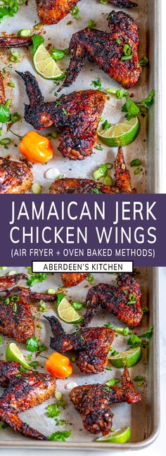 jamaican jerk chicken wings in a pan with limes and peppers