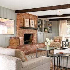 a living room filled with furniture and a fire place under a painting on the wall