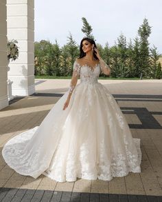 a woman in a wedding dress is posing for the camera with her hand on her hip