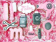 decorated cookies in a pink box with scissors, combs and hairdryer on it