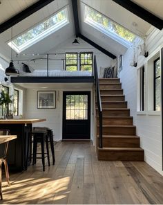 an open concept home with wood floors and white walls