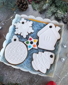 decorated cookies in a box on a table