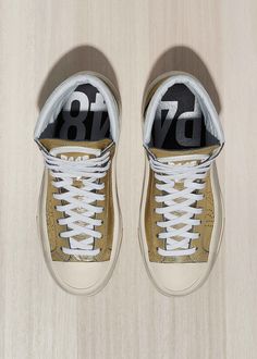 FINAL SALE: NO RETURNS. NO EXCHANGES. NO ADJUSTMENTS. AS IS. Light up any room in these metallic gold high tops. Here, off-white suede shaft trim provides perfect contrast while a big wavy sole grounds—or rather, uplifts—the look. Made in Italy Gold metallic leather upper with perforated P448 logo Gold metallic leather tongue & trim White gum leather toe Off-white suede shaft trim Terry cloth lining Memory foam insole Hand-distressed P448 rubber sole Black tread White cotton laces High Top Sneaker, Metallic Leather, Terry Cloth, Cotton Lace, Tulum, Metallic Gold, High Top, White Cotton, High Top Sneakers