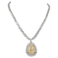 From Emilio Jewelry located on New York's iconic Fifth Avenue, featuring a hard to come by Gia certified 25.00 carat yellow diamond pear shape drop diamond. The necklace is set with an array of pear and round shape diamonds adding an additional 58.70 carats of D-F color Vvs1-vs2 diamonds! Please inquire for additional details. All pieces are hand made in the Emilio Jewelry Atelier. Our brand is proudly rated as a Top Seller on 1stDibs with 5 star customer reviews. All items manufactured by us ca Fancy Diamond Necklace, Emilio Jewelry, Jewelry Atelier, Cocktail Ring Designs, Yellow Diamond Necklace, Pink Topaz Ring, Diamond Drop Necklace, Metal Choker, Necklace Top