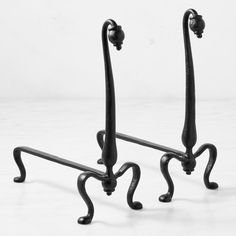 two black wrought iron hooks on a white background