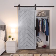 a bedroom with a bed, dresser and closet door that has an arrow pattern painted on it