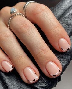 a woman's hand with pink and black french manies