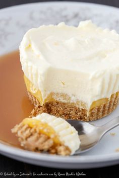 a piece of cheesecake on a plate with a fork and caramel syrup in the bowl