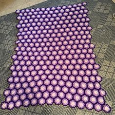 a purple and white rug on the floor