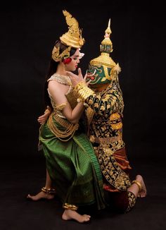 two women dressed in elaborately designed costumes