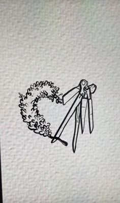 a pair of scissors with a wreath on it are drawn in black and white ink