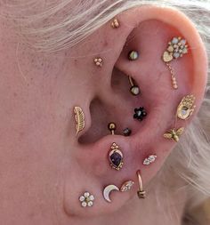 an ear with many different types of piercings on it