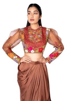 Brown crop top with floral embroidered and puff sleeves. Paired with draped skirt.
Component: 2
Embroidered
Neckline: Round
Sleeve Length: Full
Fabric: Organza, Satin
Color: Brown
Puff sleeves - Aza Fashions Fitted Embroidered Sleeve Top For Festive Occasions, Floral Embroidered Choli With Cape Sleeves For Parties, Fitted Blouse With Cape Sleeves For Reception, Party Choli With Cape Sleeves And Floral Embroidery, Party Choli With Floral Embroidery And Cape Sleeves, Floral Embroidered Choli With Cape Sleeves For Reception, Festive Party Blouse With Embroidered Sleeves, Festive Fitted Set With Embroidered Sleeves, Festive Fitted Sets With Embroidered Sleeves