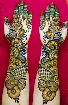 two hands with henna designs on them