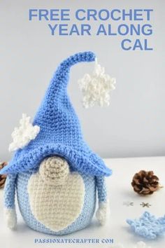 a crocheted blue and white gnome hat with snowflakes on it, next to pine cones