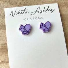 "These Love Yourself heart stud earrings are perfect for the BTS ARMY in your life! Sized at just over .5\" the studs are cut from a pastel lavender acrylic and then receive a purple color fill for the details.  The standard backs for these earrings are 99.9% pure titanium making them sensitive skin friendly. However, if you need alternative earring back options (like plastic studs) please reach out prior to placing your order, as we do have a few other options. Custom requests are welcome, so if you'd like this design in a different color combo please just send us a message! Be sure to check out Nikita Ashley Customs on Facebook, Instagram or our website - www.NikitaAshleyCustoms.com *All items are handmade so there may be small variations from piece to piece. Acrylic pieces can be fragil Trendy Purple Heart Earrings As Gift, Trendy Purple Heart Earrings For Gift, Trendy Purple Heart Earrings, Kpop Jewelry, Bts Earrings, Alternative Earrings, Kpop Earrings, Merch Kpop, Pastel Lavender