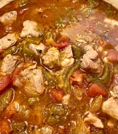 a pot filled with meat and vegetables on top of a stove