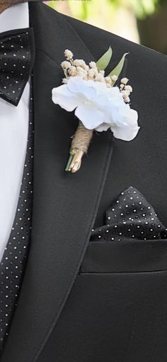 a man in a tuxedo with a boutonniere and flower on his lapel