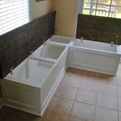 a bathtub sitting in the middle of a room next to a sliding glass door