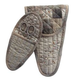 two pairs of slippers with scissors in them on a white background and one pair is made out of quilt