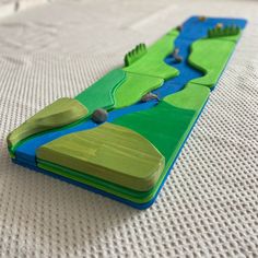 a close up of a toy boat on a bed