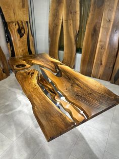 a table made out of wood with knives on it