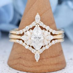 a diamond ring on top of a wooden stand