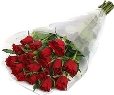 a bouquet of red roses wrapped in white paper