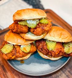 three fried chicken sandwiches stacked on top of each other