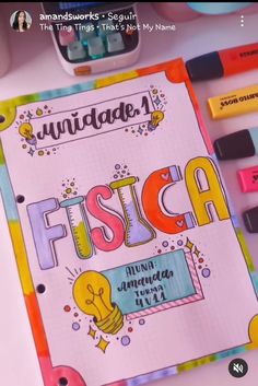 an open notebook with the word fiesta written on it next to some crayons