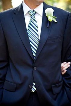 a man in a suit with a flower on his lapel