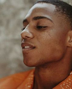 a close up of a person wearing an orange jacket